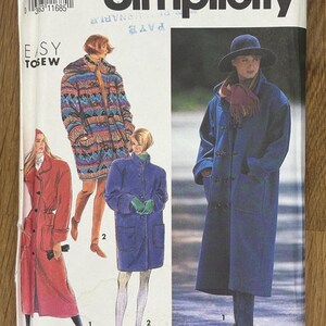 May include: A Simplicity sewing pattern envelope 7457 for coats in sizes PT-XL. The front displays illustrations of three different coat styles: a long red coat, a patterned hooded coat, and a long blue coat with toggle closures and a matching hat.