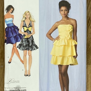 May include: Simplicity sewing pattern with dress designs. The dresses include a strapless yellow dress with tiered ruffles, a black and white floral dress with a yellow bow, and a blue and white layered dress. Pattern sizes are D5 4,6,8,10,12, EUR 30-38, FR 32-40.