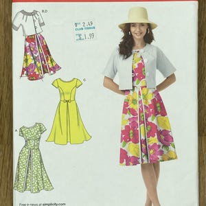 May include: Simplicity sewing pattern U5, sizes 16-24. The pattern shows a woman in a floral dress, jacket, and hat. Other dress designs are illustrated. The word "Simplicity" is at the top. Measurements are in cm.