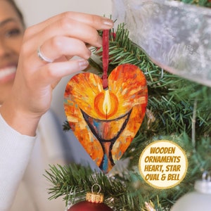 May include: A wooden heart-shaped Christmas ornament with a painted image of a candle in a chalice. The ornament is hanging on a Christmas tree.