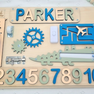 Educational Montessori busy board for toddlers with personalized puzzle name, shoe Velcro, shoe with lace, maze, zipper training, fun wheels, buckle opening and closing exercise, lock, switch and fun wheel. This busy board will keep your child busy.