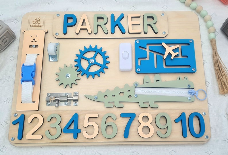 Educational Montessori busy board for toddlers with personalized puzzle name, shoe Velcro, shoe with lace, maze, zipper training, fun wheels, buckle opening and closing exercise, lock, switch and fun wheel. This busy board will keep your child busy.