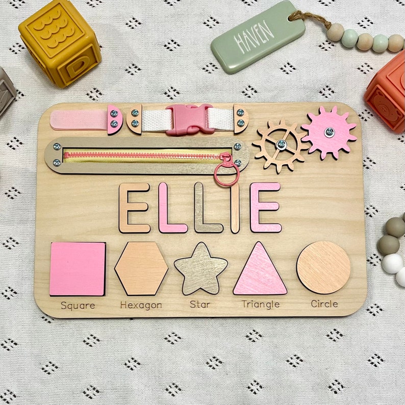 Educational Montessori busy board for toddlers with personalized puzzle name, shoe Velcro, shoe with lace, maze, zipper training, fun wheels, buckle opening and closing exercise, lock, switch and fun wheel. This busy board will keep your child busy.