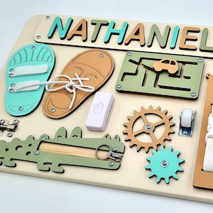 Educational Montessori busy board for toddlers with personalized puzzle name, shoe Velcro, shoe with lace, maze, zipper training, fun wheels, buckle opening and closing exercise, lock, switch and fun wheel. This busy board will keep your child busy.