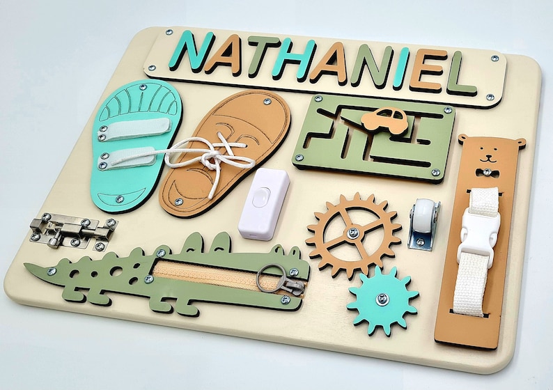 Educational Montessori busy board for toddlers with personalized puzzle name, shoe Velcro, shoe with lace, maze, zipper training, fun wheels, buckle opening and closing exercise, lock, switch and fun wheel. This busy board will keep your child busy.