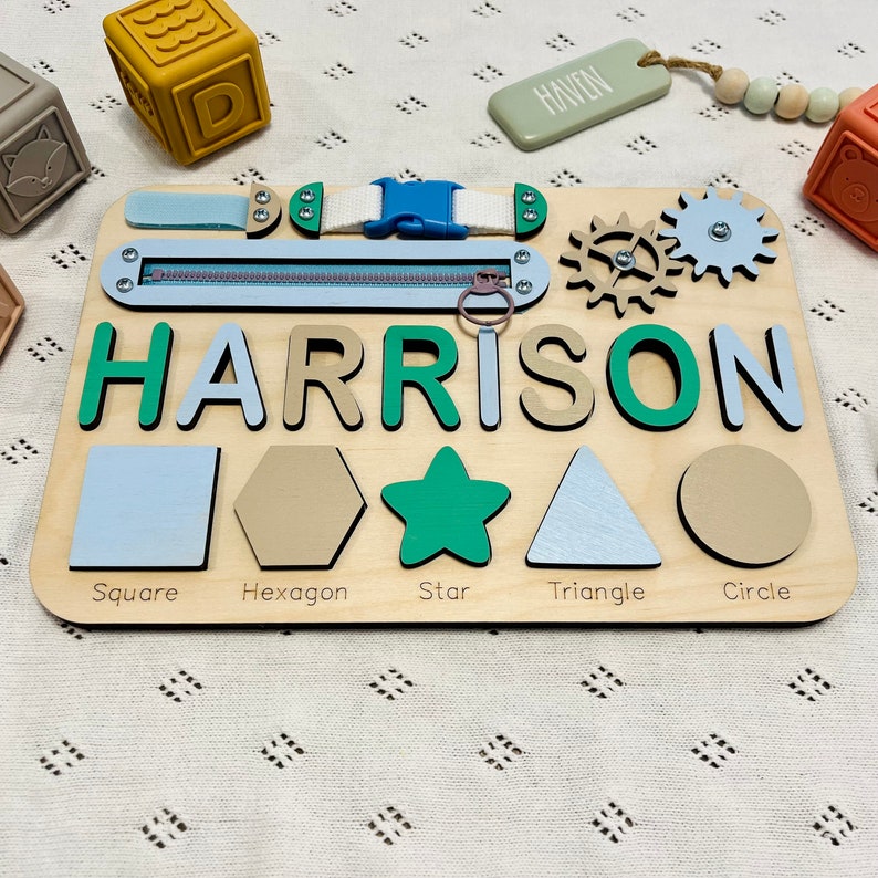 Montessori busy board with zipper, Velcro, spinning wheels and different shapes. Personalized name puzzle board for kids. Square, hexagon, star, triangle, circle shapes for puzzle board. Baby name puzzle board. Christmas gift or first birthday gift