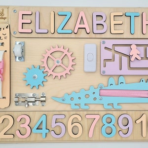 Educational Montessori busy board for toddlers with personalized puzzle name, shoe Velcro, shoe with lace, maze, zipper training, fun wheels, buckle opening and closing exercise, lock, switch and fun wheel. This busy board will keep your child busy.