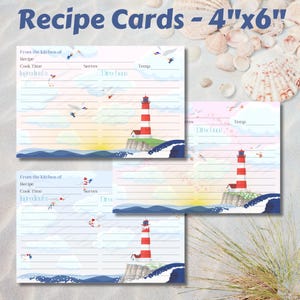 May include: Recipe cards, 4"x6", feature a lighthouse design with red and white stripes, set against a blue ocean and sky. The cards include spaces for recipe details, cook time, ingredients, and directions. Seagulls and a sunrise are also depicted.
