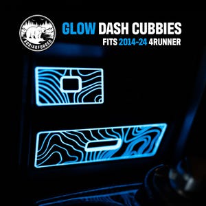 May include: Two rectangular glow-in-the-dark dash cubby inserts with a blue topographic line pattern, designed for 2014-24 4Runner vehicles. The text GLOW DASH CUBBIES FITS 2014-24 4RUNNER and a Kodiakforged bear logo are visible at the top.