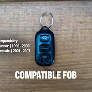 May include: A black remote key fob with three buttons featuring icons for window, unlock, and lock functions, attached to a silver metal keyring. Text reads: Compatability: Toyota | 4Runner | 1999 - 2009 Toyota | Sequoia | 2001 - 2007 COMPATIBLE FOB