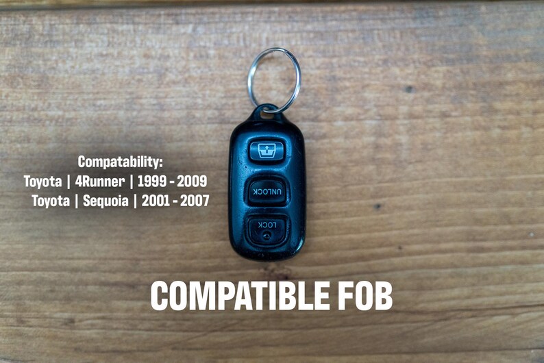 May include: A black remote key fob with three buttons featuring icons for window, unlock, and lock functions, attached to a silver metal keyring. Text reads: Compatability: Toyota | 4Runner | 1999 - 2009 Toyota | Sequoia | 2001 - 2007 COMPATIBLE FOB