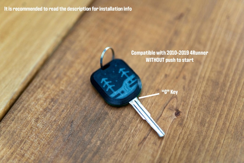 May include: A black car key with a metal blade and a plastic head featuring a light blue graphic of trees and a landscape. Text on the image reads: It is recommended to read the description for installation info, Compatible with 2010-2019 4Runner WITHOUT push to start, and G Key.