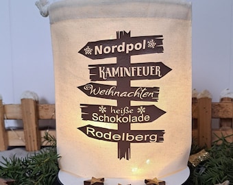 Light bag Christmas signpost North Pole. Lantern Advent. Suitable for Christmas winter village. Gift packaging and light decoration in one.