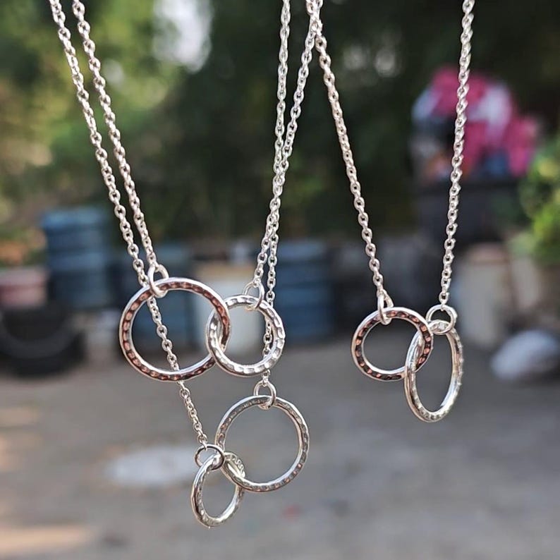 A minimalist sterling silver necklace with two connected circles. This is a unity necklace.