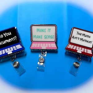 May include: Three glitter laptop-shaped retractable badge holders. The first one is blue with the text "Did You Document?" The second one is pink with the text "Make It Make Sense". The third one is red with the text "The Math Ain't Mathin'".