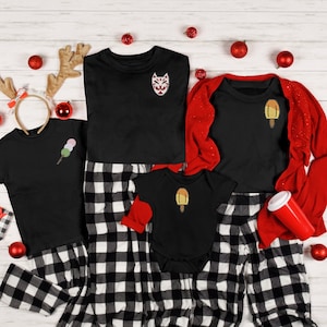 May include: A family matching pyjama set with a black and white checked pattern. The pyjamas feature different Japanese-inspired designs, including a fox mask, popsicle, and dango.