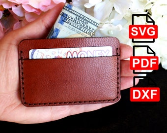 May include: A brown leather card holder with a stitched edge. The card holder has a pocket for cash and a slot for cards. The card holder is being held in a hand. The image also includes the text "SVG", "PDF", and "DXF".