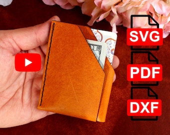 May include: A brown leather wallet with a single bill slot and a flap closure. The wallet is being held in a hand. The image also includes a play button icon and text that says "SVG", "PDF", and "DXF".