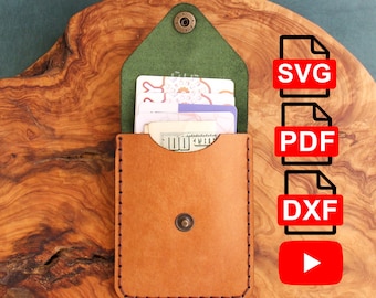 May include: A brown leather wallet with a green flap and a snap closure. The wallet is sitting on a wooden surface. The wallet is open and has several cards and cash inside. The image also includes text for SVG, PDF, DXF file formats and a play button.
