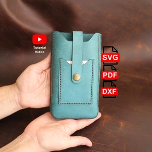 May include: A teal leather phone pouch featuring a vertical strap with a brass snap button closure and an external pocket. The image includes icons for Tutorial Video, SVG, PDF, and DXF files, indicating a digital pattern for this leather item.