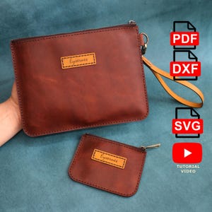 May include: Two brown leather pouches, one large and one small, with the word "Eysernes" on a rectangular patch. The larger pouch has a wrist strap. The image also includes icons for PDF, DXF, SVG, and a tutorial video.