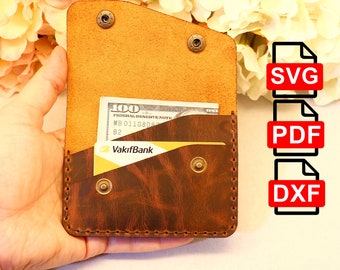 May include: A brown leather wallet with a flap and a stitched edge. The wallet has a billfold, a card slot, and a snap closure. The wallet is open and shows a $100 bill and a credit card with the text "VakifBank".