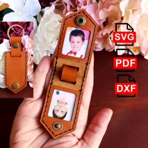 May include: A brown leather photo keyring with two photo slots. The keyring has a stitched edge and a metal ring. The keyring is in the hand of a person. The image shows the text "SVG", "PDF", and "DXF" on the right side of the image.