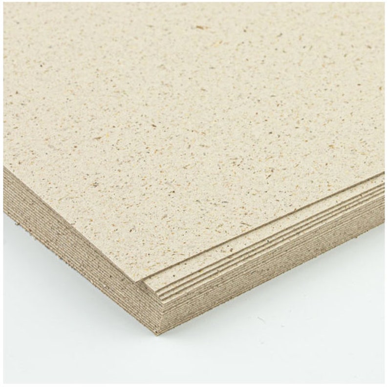 May include: A stack of beige cardstock paper with a speckled texture.