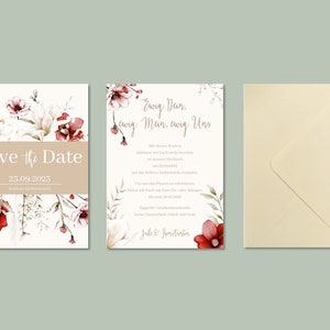 May include: Save the Date card with a floral design in shades of red and white. The text reads "Save the Date" and "23.09.2023". A second card with a floral design in shades of red and white. The text reads "Ewig Dein, ewig Mein, ewig Uns".