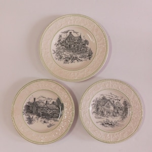 May include: Three white ceramic plates with green trim and black and white illustrations of houses. The plates feature the names "The Old Vicarage", "The Old Village", and "The Old Mill".