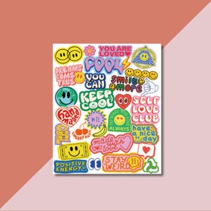 May include: A sticker sheet featuring a collection of colorful, multi-shaped decals with various designs including smiley faces, hearts, cherries, a banana, and text phrases such as YOU ARE LOVED, KEEP COOL, SELF LOVE CLUB, and STAY WEIRD.