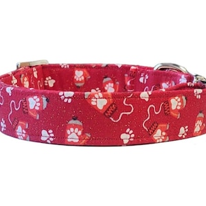 May include: Red dog collar with a white paw print and mitten pattern.