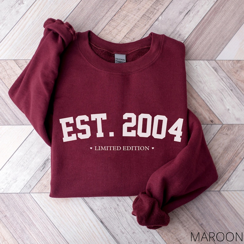 May include: Maroon sweatshirt with white text that reads "EST. 2004" and "LIMITED EDITION".
