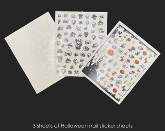 May include: Three sheets of Halloween nail stickers. One sheet features skulls, another has various Halloween-themed images like pumpkins and ghosts. The third sheet has a pattern. The text at the bottom reads: 3 sheets of Halloween nail sticker sheets.