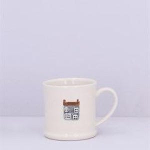 May include: White ceramic mug with a brown and white illustration of a building with windows. The mug has a rounded handle.