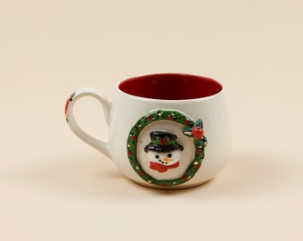 Tekopp | Kaffekopp | Dekorerad med en snögubbe | Handgjord av keramik | Med äkta gulddetaljer | Designerkopp