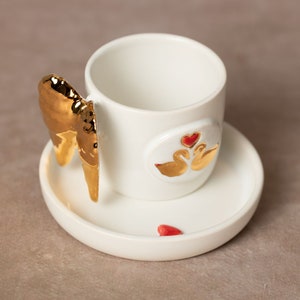 Coffee cup | Tea cup | Decorated with an angel wing & 2 swans | Handmade | Pottery | Real gold elements | Designer cup