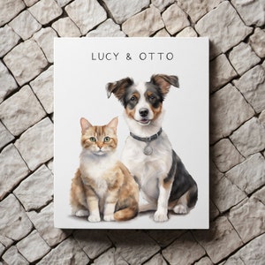 May include: A white canvas print with a watercolor illustration of a brown and white dog and a brown and orange cat. The dog is sitting with its head tilted and its mouth closed. The cat is sitting with its head straight and its mouth closed. The text "LUCY & OTTO" is printed at the top of the canvas.