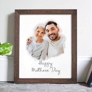 May include: A framed print featuring a watercolour-style photograph of a woman and a man smiling. The text "Happy Mothers Day" is written below the photo.