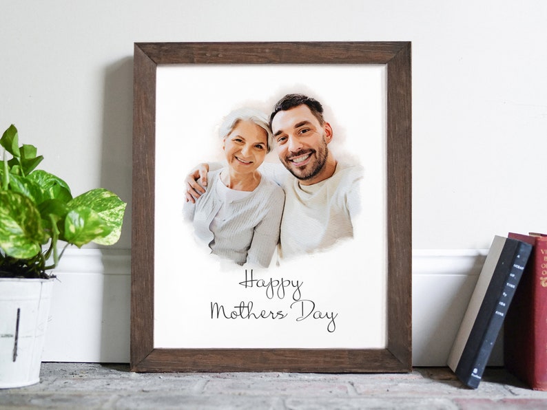 May include: A framed print featuring a watercolour-style photograph of a woman and a man smiling. The text "Happy Mothers Day" is written below the photo.