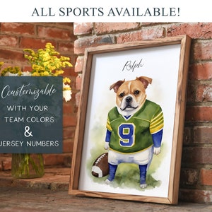 May include: A watercolor painting of a bulldog wearing a green and yellow football jersey with the number 9 on it. The dog's name, "Ralph", is written above the dog. The painting is framed in a wooden frame and is set against a brick wall.