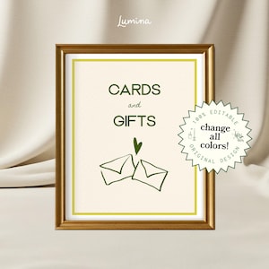May include: A framed sign with the words "CARDS and GIFTS" in green, with a green heart and envelope illustration. The sign is in a gold frame with a cream background. A circular sticker says "change all colors!"