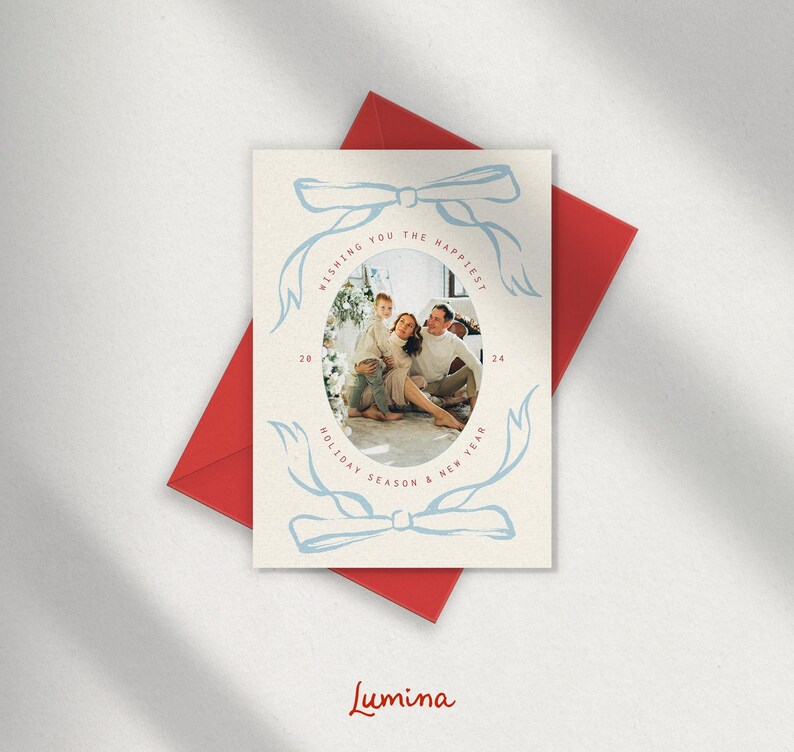 May include: A Christmas card with a blue and white design featuring a family of three in a photo. The text on the card reads "Wishing you the happiest holiday season & new year".