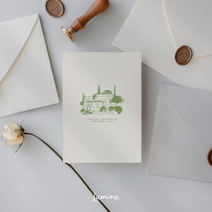 May include: A white card with a green illustration of a building with trees and the text "Villa del Balbianello, Lake Como, Italy". The card is surrounded by white envelopes with wax seals.