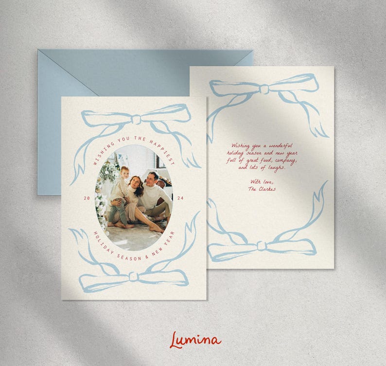 May include: A Christmas card with a blue and white illustration of a bow and a family photo inside. The text reads "Wishing you the happiest holiday season & new year 2024".
