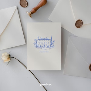 May include: A white card with a blue illustration of a building with trees and the text "Villa Balbiano, Lake Como, Italy". The card is surrounded by white envelopes with wax seals.