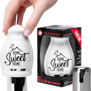 May include: A white porcelain air gap cover with the text "Home Sweet Home" in black script. The product is displayed with its packaging, which includes the text "Cap in America" and "United Air Gap Covers". A chrome-colored cap is also shown.