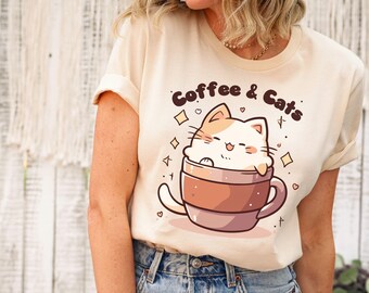 May include: A beige t-shirt with a cartoon cat in a coffee cup. The text "Coffee & Cats" is printed on the shirt.