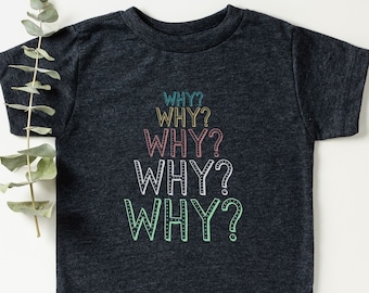 May include: A dark gray t-shirt with the word "WHY?" repeated five times in different colors, including teal, pink, yellow, and green.