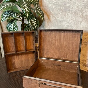 May include: A wooden box with a drawer and a removable top section. The box has a compartment with multiple sections. The drawer has a rope design and the text "you do not yield" engraved on it.